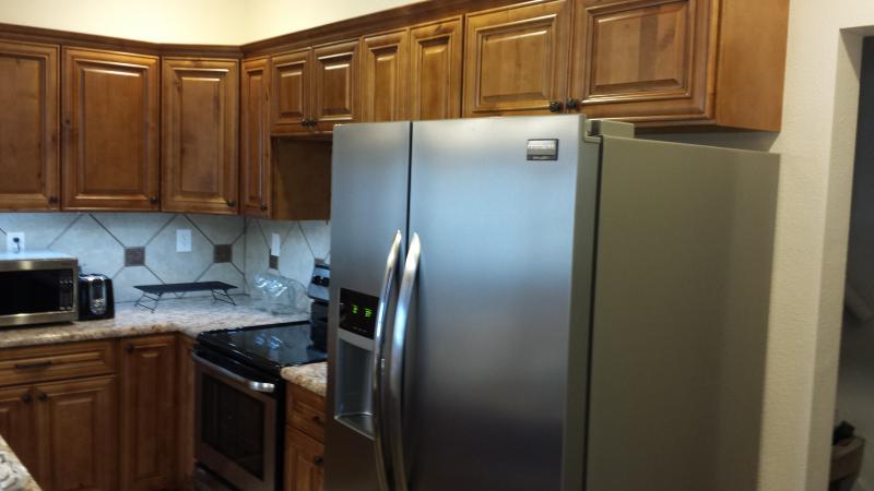 knotty maple cabinets stainless steel refrigerator with Ice and water in door